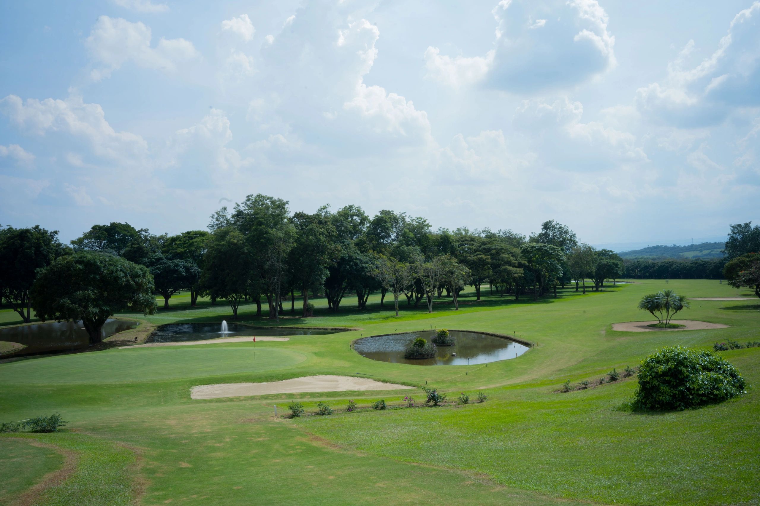 Golf course with sand trap and water hazard