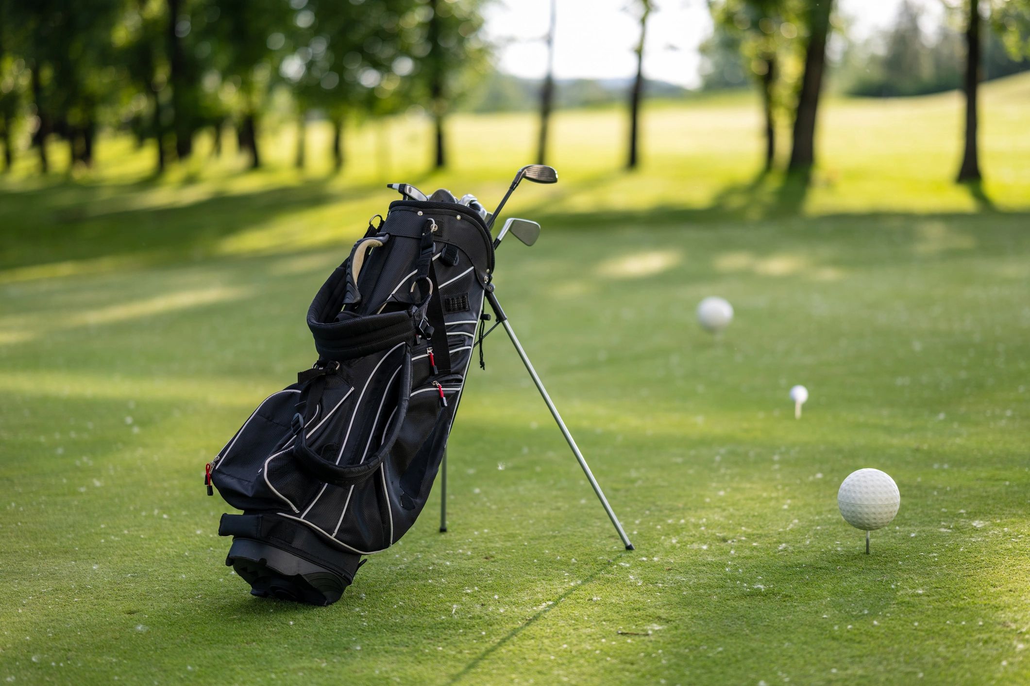 Golf practice area with clubs and balls on the green